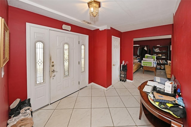 foyer with light tile patterned flooring