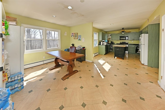 office featuring baseboard heating, plenty of natural light, and baseboards