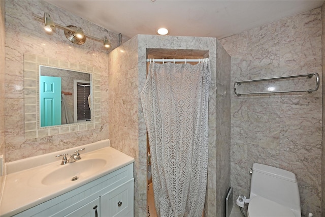 full bath with toilet, vanity, tile walls, and a shower with curtain