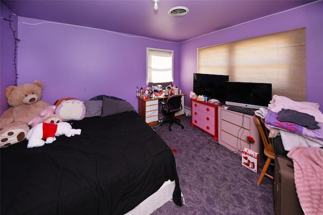 carpeted bedroom with visible vents and baseboard heating