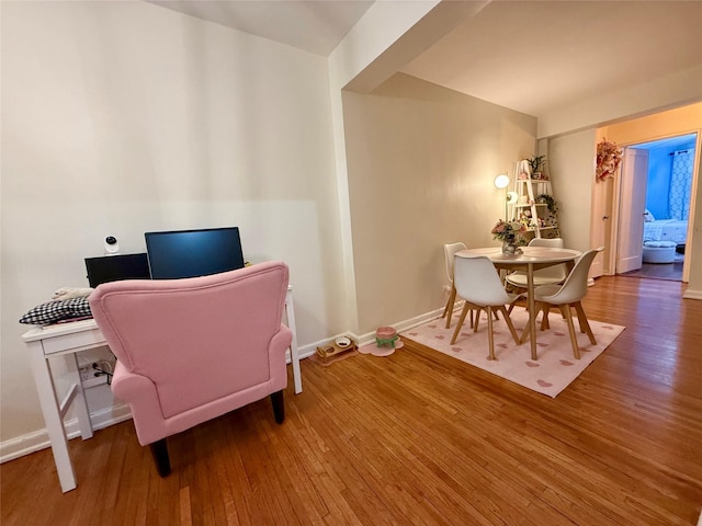 interior space with wood finished floors and baseboards