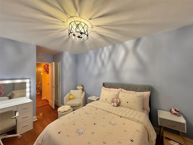 bedroom with dark wood-type flooring