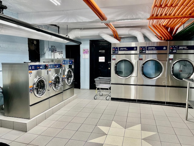 common laundry area with washing machine and dryer and tile patterned floors