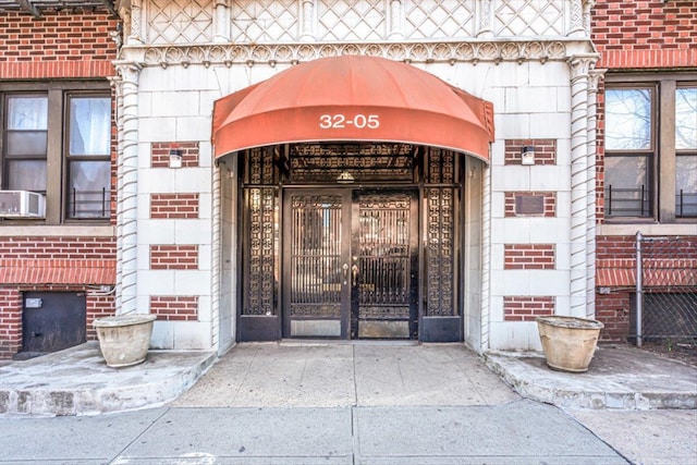 view of exterior entry with brick siding