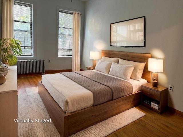 32-05 81st St Unit A3, Jackson Heights, NY 11370 - bedroom featuring radiator, baseboards, and wood finished floors