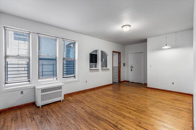 32-05 81st St Unit A3, Jackson Heights, NY 11370 - empty room with radiator, baseboards, and wood finished floors