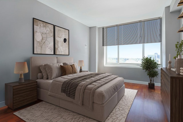 bedroom with dark wood-style floors and baseboards