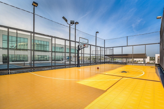 view of basketball court featuring community basketball court and fence