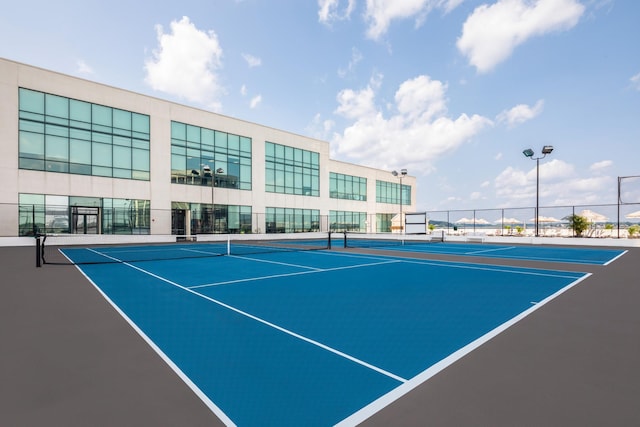 view of tennis court featuring fence