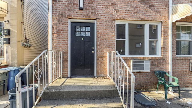 view of exterior entry with brick siding