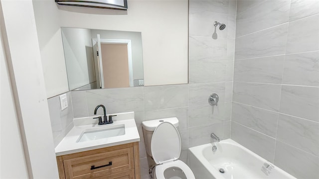 bathroom featuring toilet, shower / bath combination, vanity, tile walls, and decorative backsplash