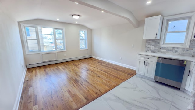 kitchen with lofted ceiling, dishwashing machine, baseboard heating, white cabinetry, and backsplash