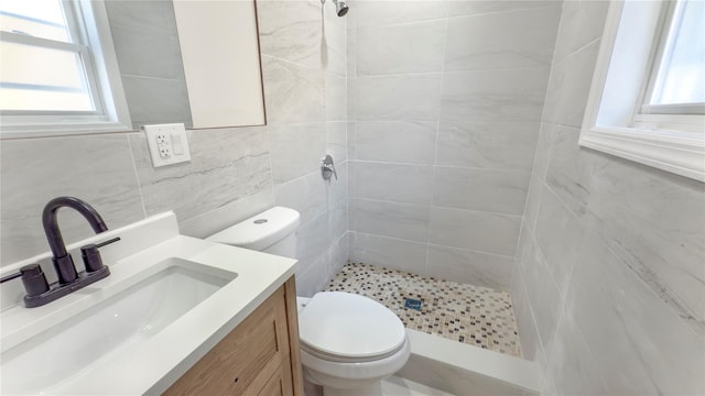 bathroom with plenty of natural light, a shower stall, and toilet