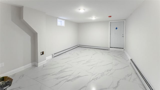 interior space with a baseboard heating unit, marble finish floor, and baseboards