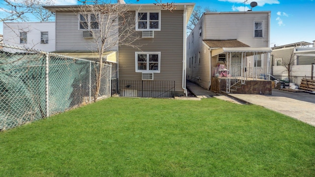 rear view of property featuring a fenced backyard and a yard