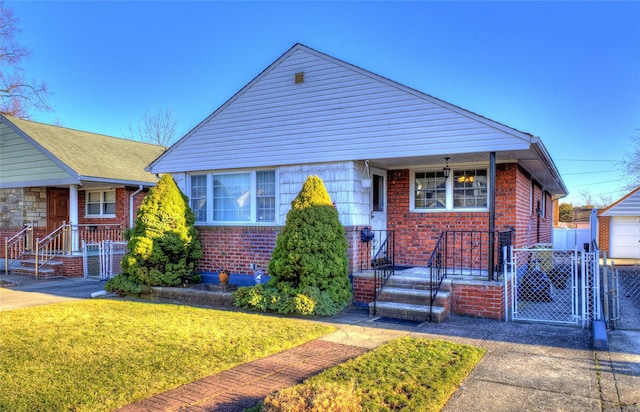 bungalow-style house featuring a front yard, a gate, brick siding, and fence