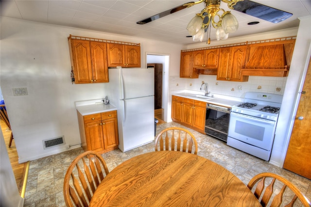 kitchen with custom exhaust hood, tasteful backsplash, light countertops, a sink, and white appliances