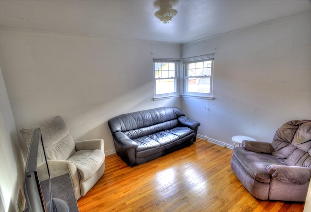 living area featuring hardwood / wood-style floors and baseboards