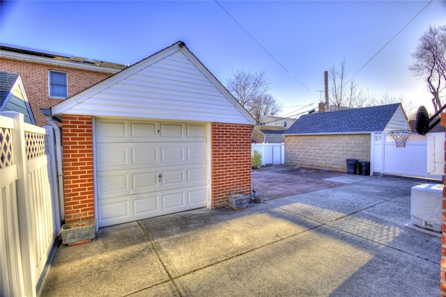 detached garage featuring fence