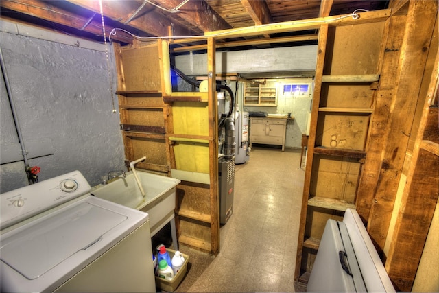 unfinished basement with washer / clothes dryer, water heater, a sink, and tile patterned floors