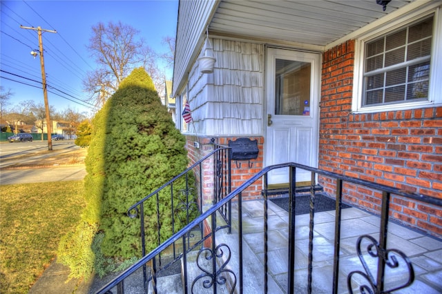 doorway to property featuring brick siding