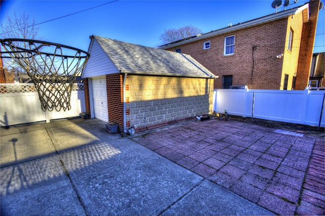 detached garage featuring fence