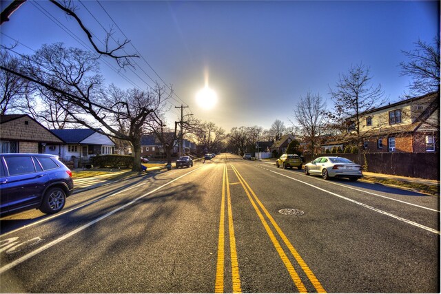 view of road featuring a residential view and sidewalks