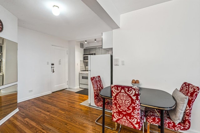 dining room featuring dark wood-style floors and baseboards