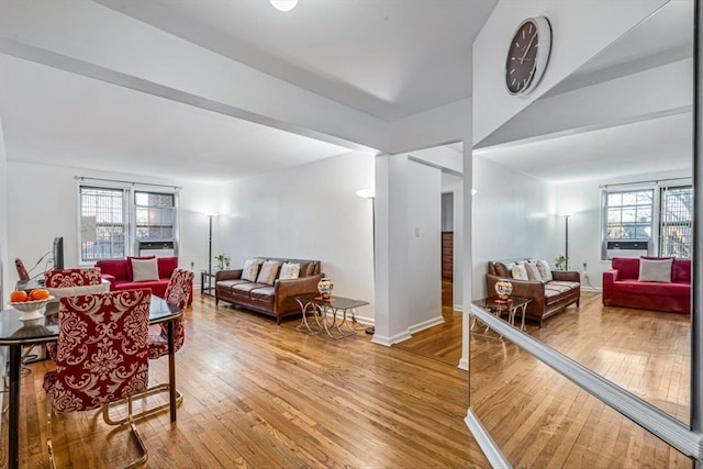 dining room featuring a wealth of natural light, baseboards, and hardwood / wood-style flooring