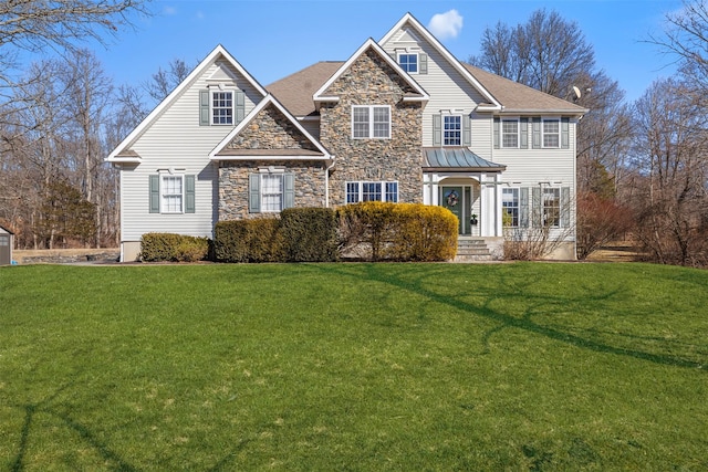 view of front of home featuring stone siding and a front lawn