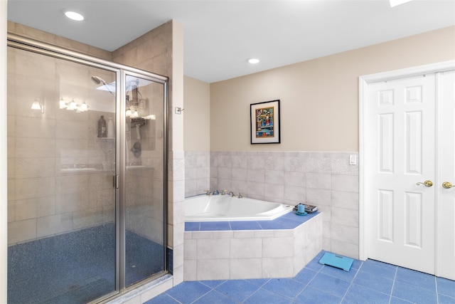 full bath with a stall shower, tile patterned flooring, recessed lighting, and a bath