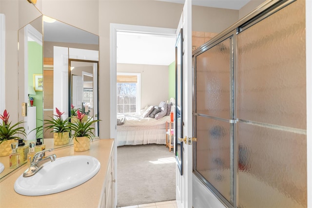 ensuite bathroom featuring bath / shower combo with glass door, ensuite bath, and vanity