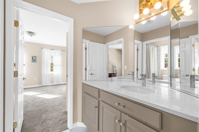 bathroom with vanity and baseboards