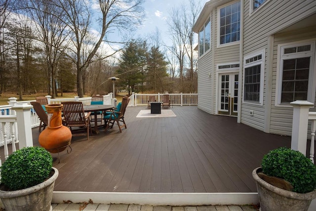 deck with outdoor dining space and french doors