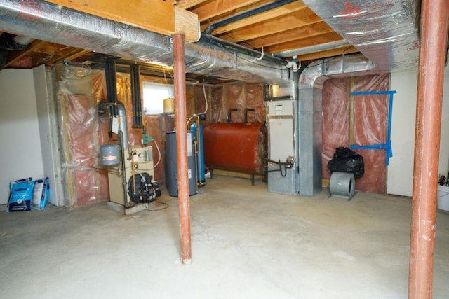 unfinished below grade area with gas water heater, heating fuel, and heating unit