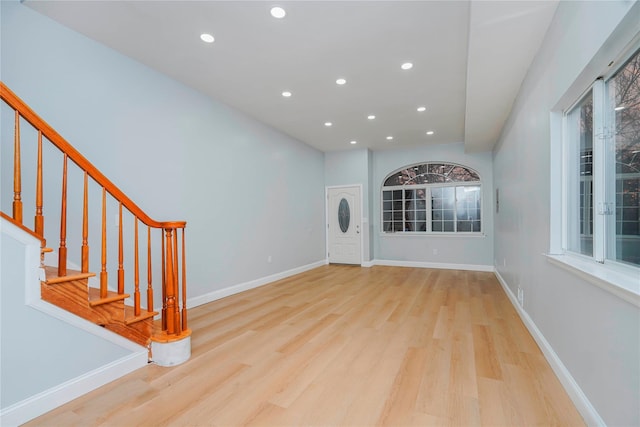 foyer with stairway, recessed lighting, wood finished floors, and baseboards