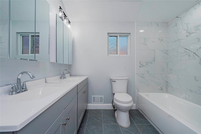 bathroom featuring toilet, a sink, visible vents, and baseboards