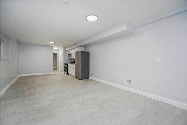 unfurnished living room with visible vents and baseboards