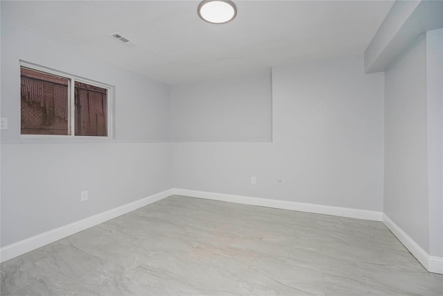 empty room featuring visible vents and baseboards