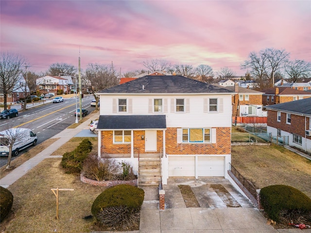 view of front of house with brick siding, a residential view, concrete driveway, and a garage