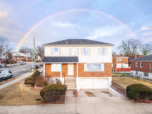 view of front of property with brick siding, an attached garage, a shingled roof, and driveway