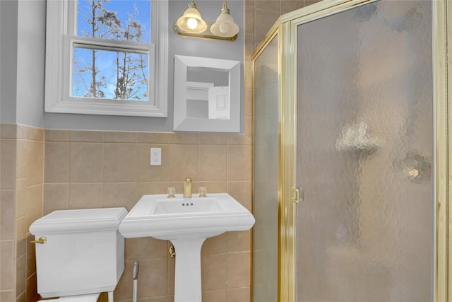 full bathroom with toilet, a shower stall, and tile walls