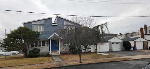 view of front of property with entry steps, an attached garage, brick siding, driveway, and a front lawn