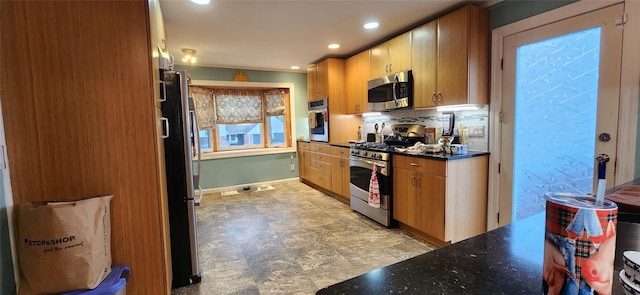 kitchen featuring recessed lighting, stainless steel appliances, baseboards, tasteful backsplash, and stone finish floor