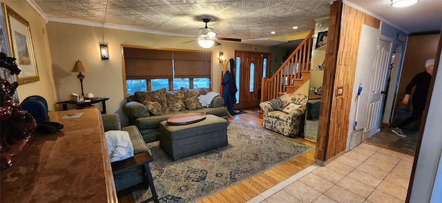 living room with light tile patterned floors, an ornate ceiling, stairs, and ornamental molding