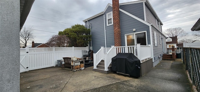 view of side of home featuring a patio and fence