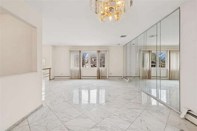 unfurnished room with visible vents, marble finish floor, baseboard heating, and a wealth of natural light