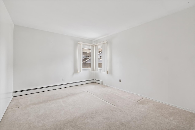 carpeted spare room with baseboard heating