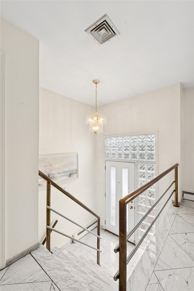 entrance foyer with visible vents, stairway, marble finish floor, french doors, and a chandelier