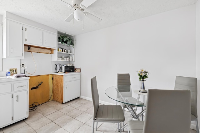 kitchen with open shelves, white cabinets, and a textured ceiling